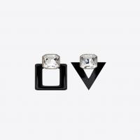 saint laurent smoking unmatched earrings in black resin and white crystals