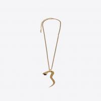 saint laurent snake pendant in gold metal with a black glass bead.