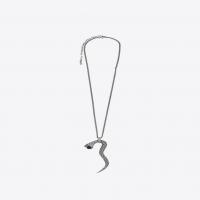 saint laurent snake pendant in silver metal with a black glass bead.
