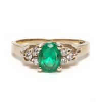 natural oval cut emerald and diamond ring in 14kt yellow gold