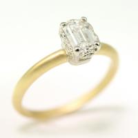 two tone ribbon crown ring in 18k yellow and white gold with .71ct emerald cut diamond